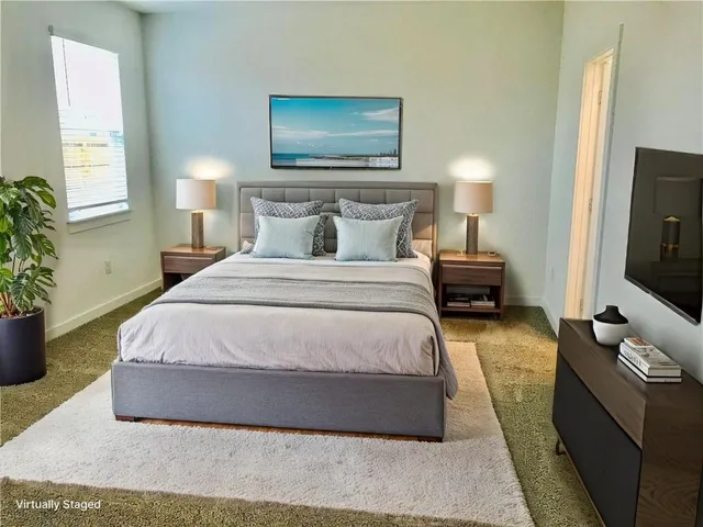 a bedroom with a bed and flat screen tv