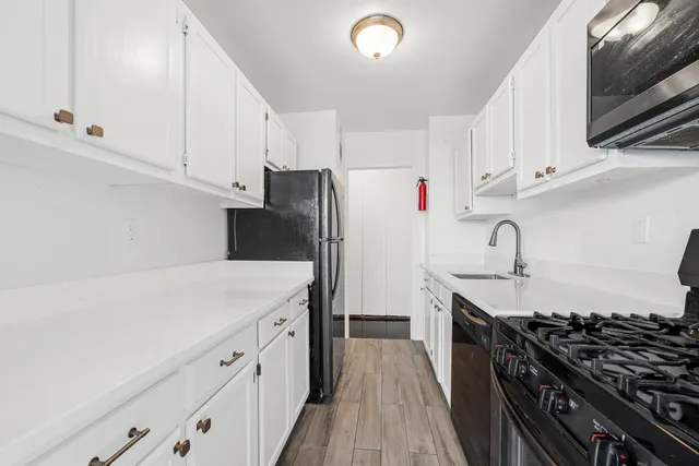 a kitchen with stainless steel appliances a sink dishwasher stove and refrigerator