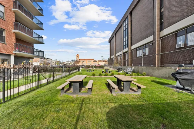 a view of a swimming pool with lawn chairs and a yard