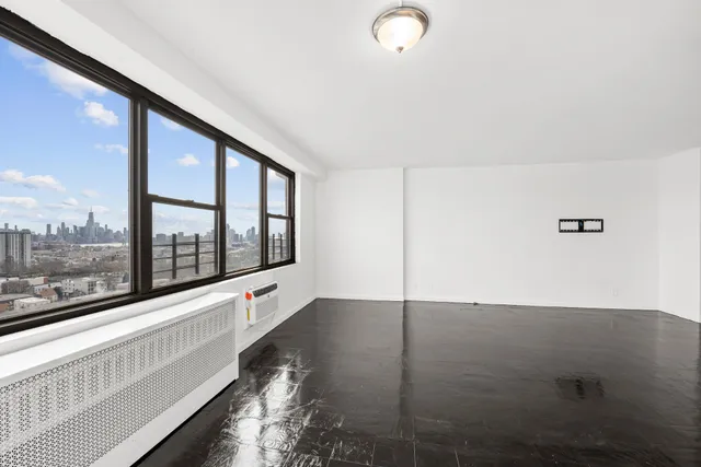 an empty room with large windows