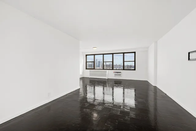 a view of house with wooden floor and a floor to ceiling window