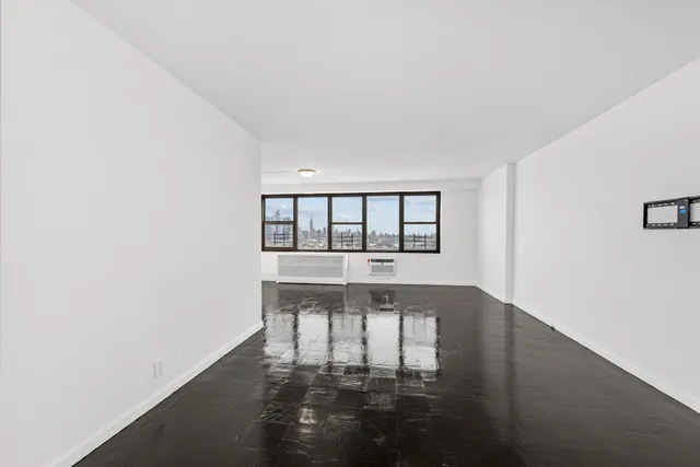 a view of wooden floor and windows in a room