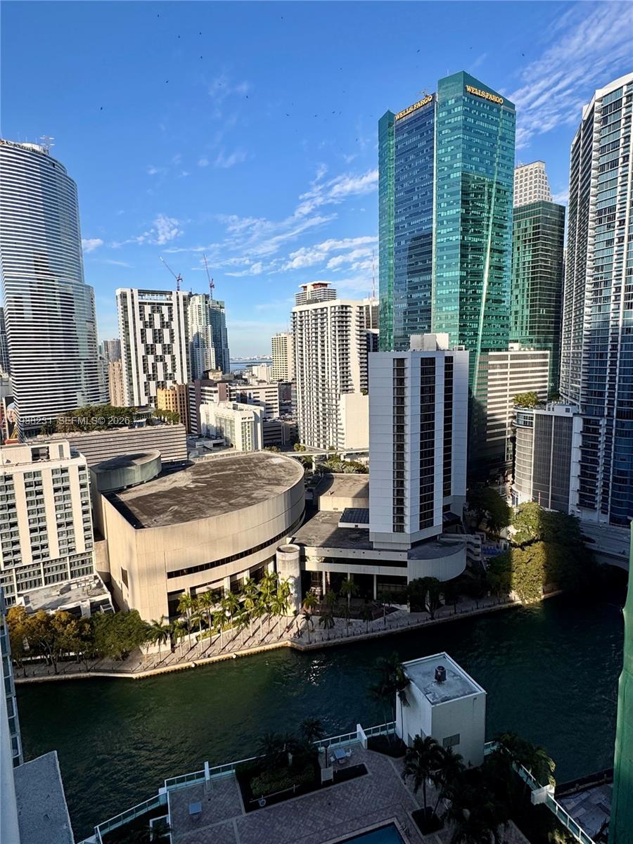 31 Southeast 5th Street, Unit 2710 Miami, FL 33131 - Photo 11 of 25 a kitchen with a stove a refrigerator and a dining table