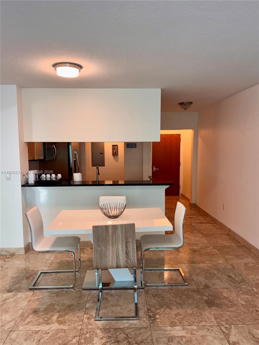 31 Southeast 5th Street, Unit 2710 Miami, FL 33131 - Photo 3 of 25 a living room with furniture a rug and white walls