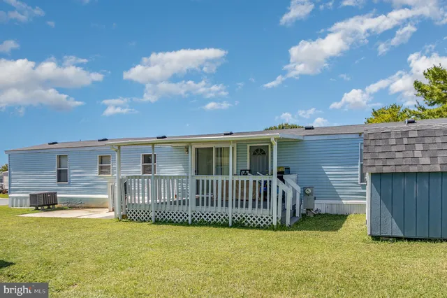 a view of a house with a tub and a yard