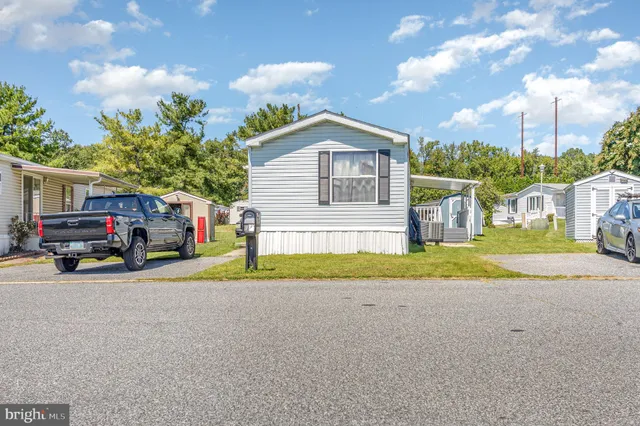 a yellow house with trees in front of it