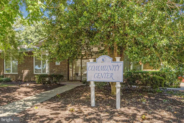 a sign board with wooden fence