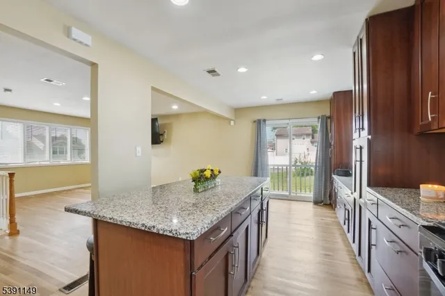 a kitchen with granite countertop kitchen island sink stove and granite counter top