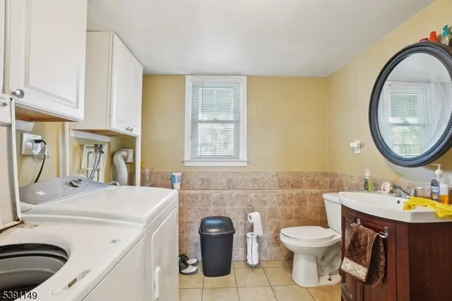 a bathroom with a sink a toilet and a mirror