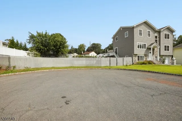 a view of a house with a swimming pool and a yard