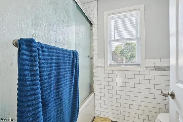 a bathroom with a shower and a window