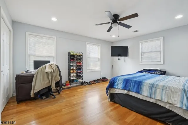 a bedroom with a bed and a ceiling fan