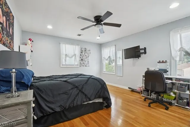 a bedroom with a bed and a desk