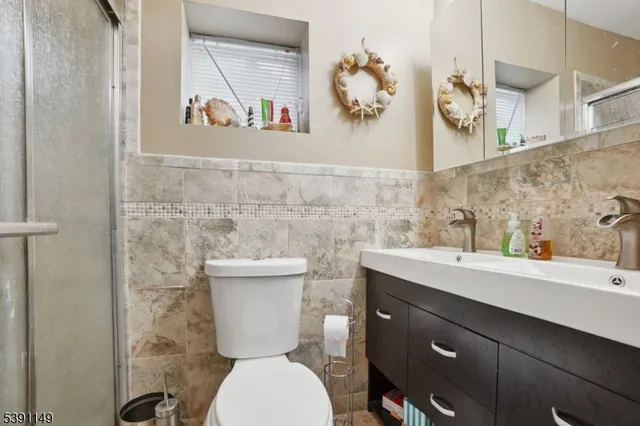a bathroom with a toilet sink and mirror