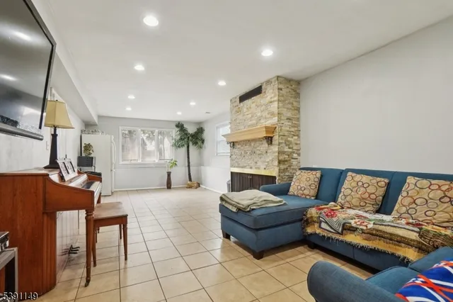 a living room with furniture and a fireplace