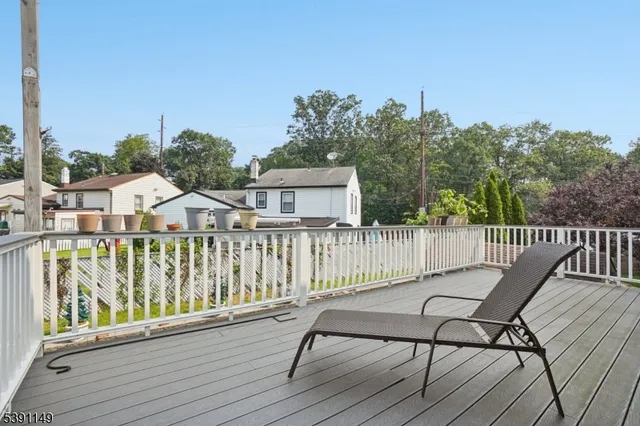 a view of a wooden chairs and floor on roof deck