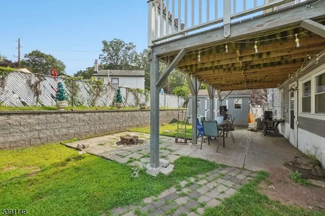 a view of a patio with table and chairs potted plants