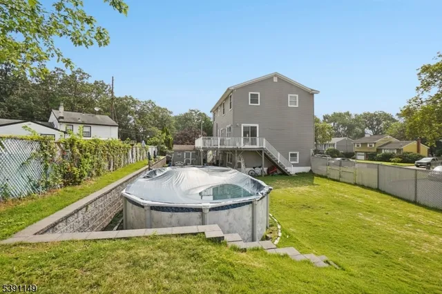 a aerial view of a house with swimming pool and large trees
