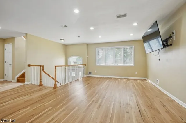 a view of a livingroom with wooden floor and a window