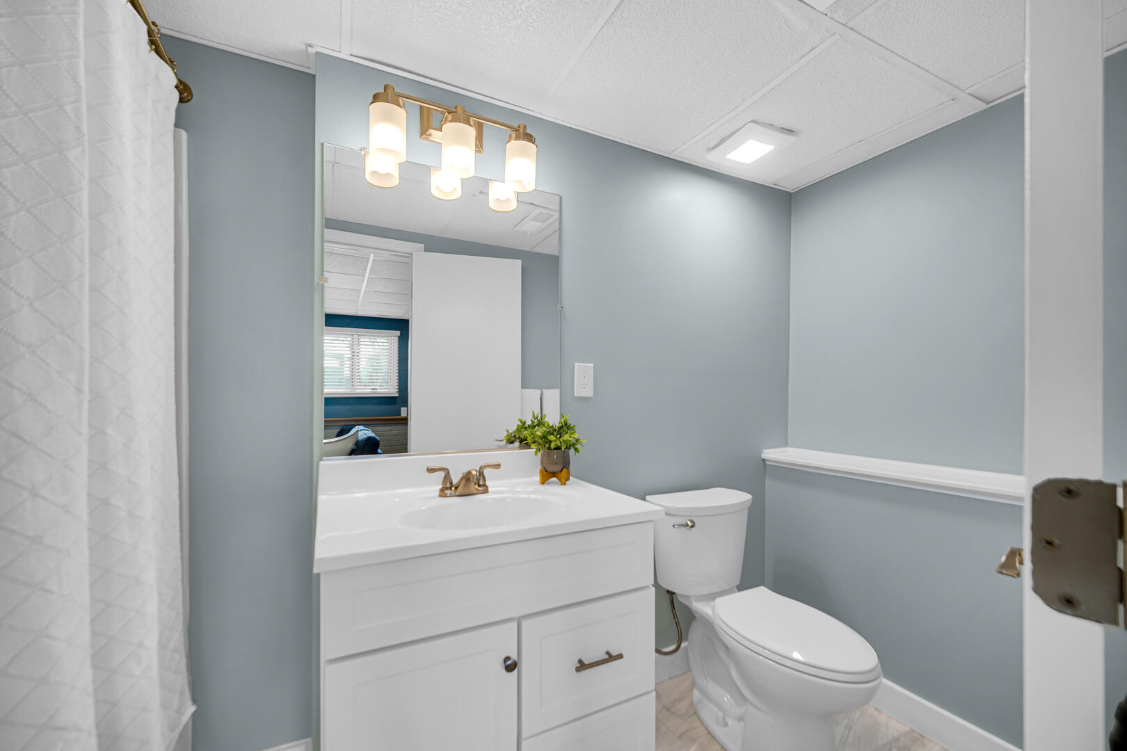 1515 West 94th Avenue Crown Point, IN 46307 - Photo 22 of 23 a bathroom with a sink a toilet and a mirror