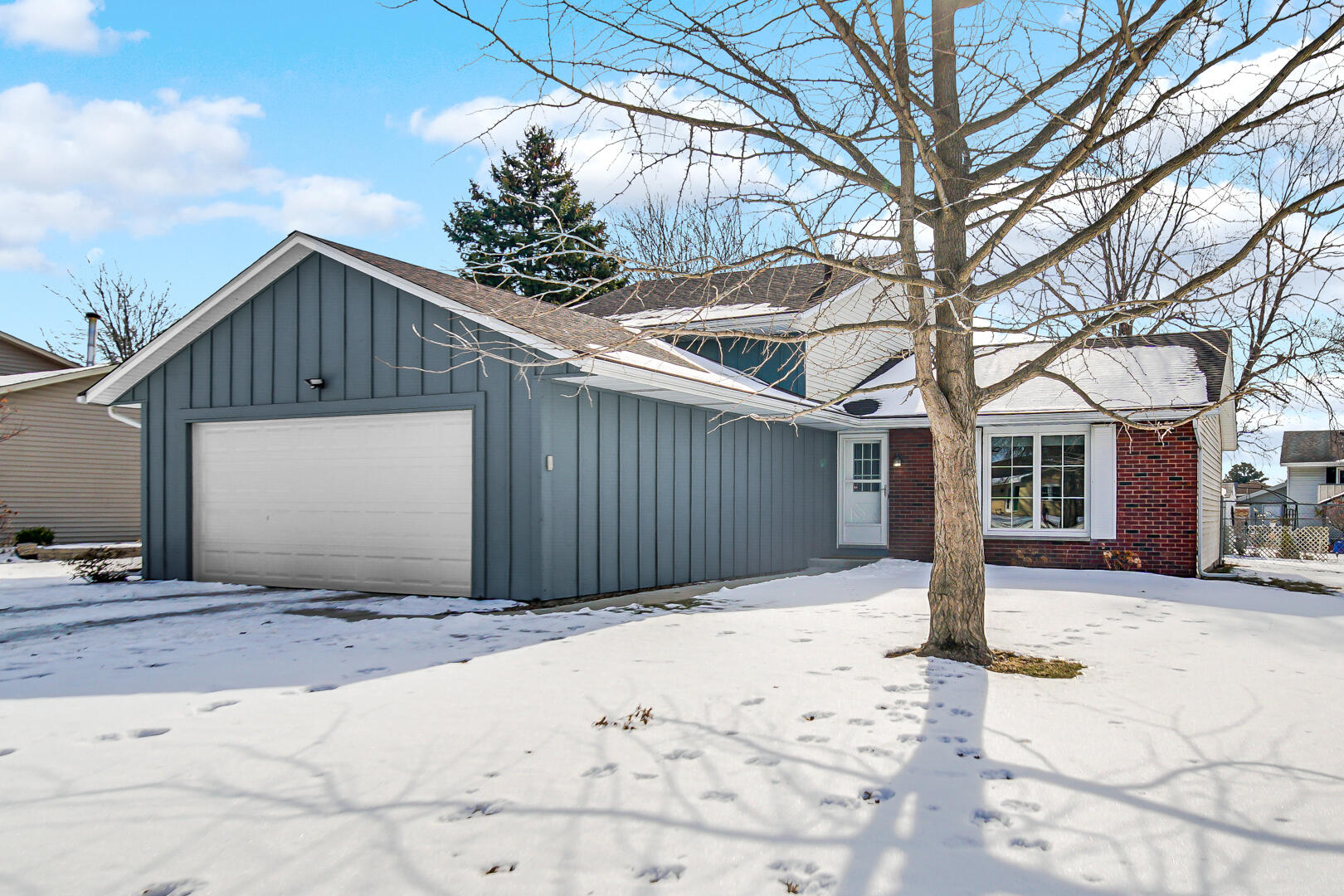 1515 West 94th Avenue Crown Point, IN 46307 - Photo 3 of 23 a front view of a house with a yard and garage