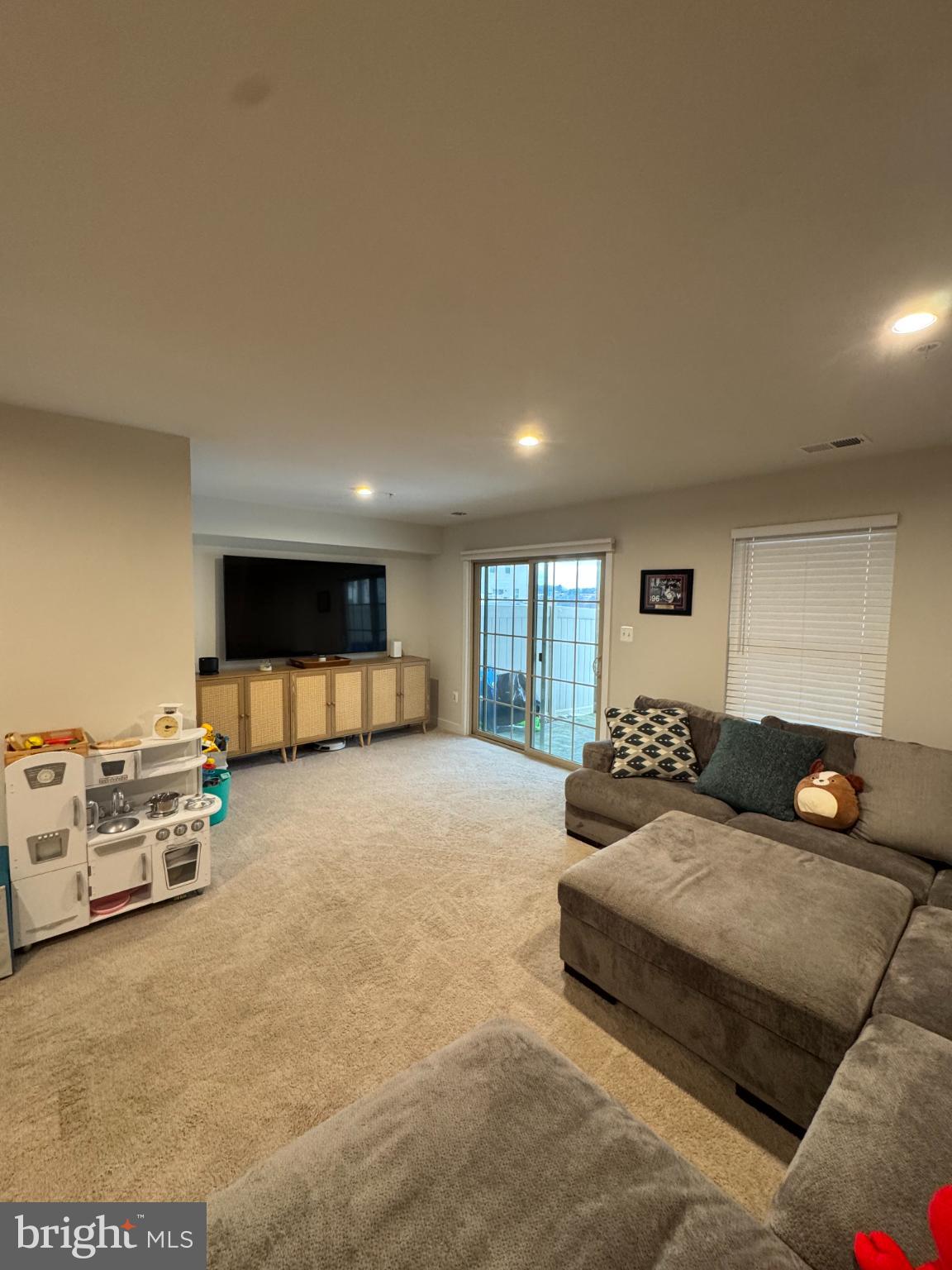 10706 Lamoka Lane New Market, MD 21774 - Photo 12 of 27 a living room with furniture and a flat screen tv