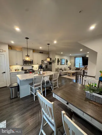 a kitchen with a table chairs microwave and cabinets