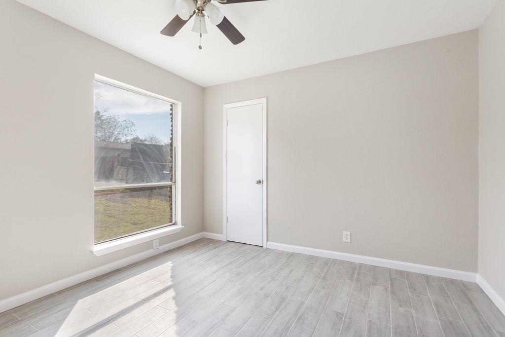 9604 Crown Ridge Road Austin, TX 78753 - Photo 17 of 24 A quiet bedroom offering tiled flooring, a single window, and a ceiling fan for comfortable living.