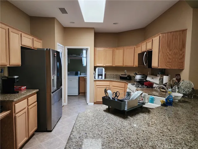 a kitchen with sink refrigerator and cabinets