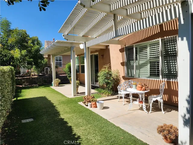 a view of a house with backyard porch and sitting area