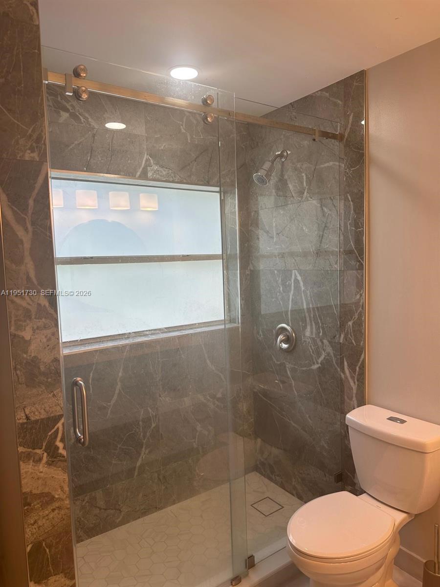 19922 Dinner Key Drive Boca Raton, FL 33498 - Photo 14 of 18 a bathroom with a shower and a toilet