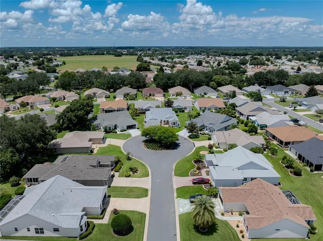 an aerial view of multiple house with a yard