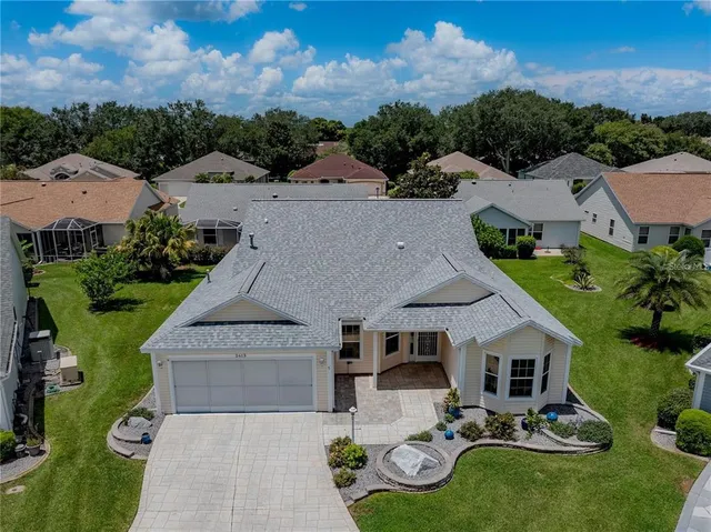 an aerial view of a house with garden space and street view