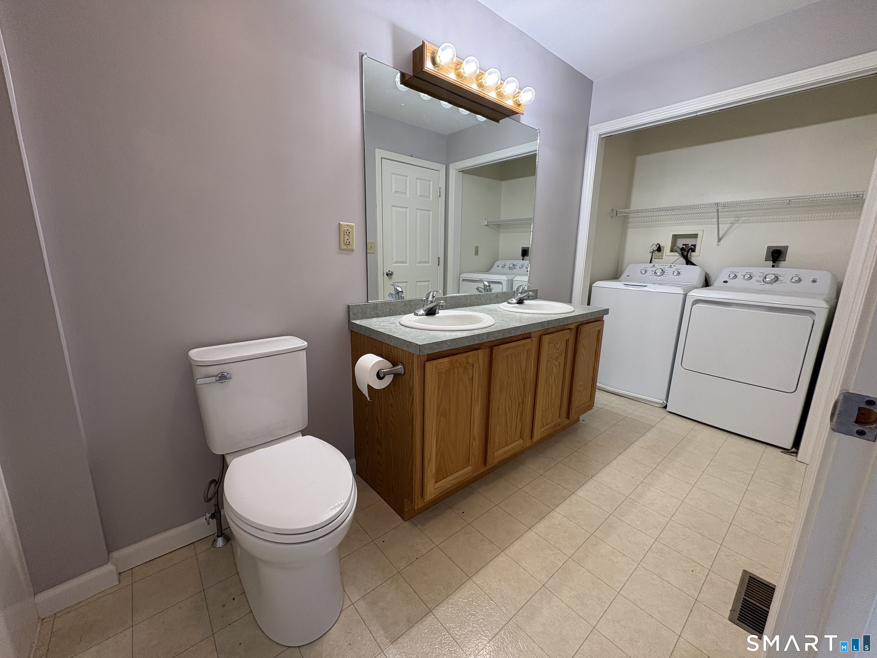 267 Bridge Street, Unit 18 Groton, CT 06340 - Photo 11 of 16 a bathroom with a toilet sink and mirror