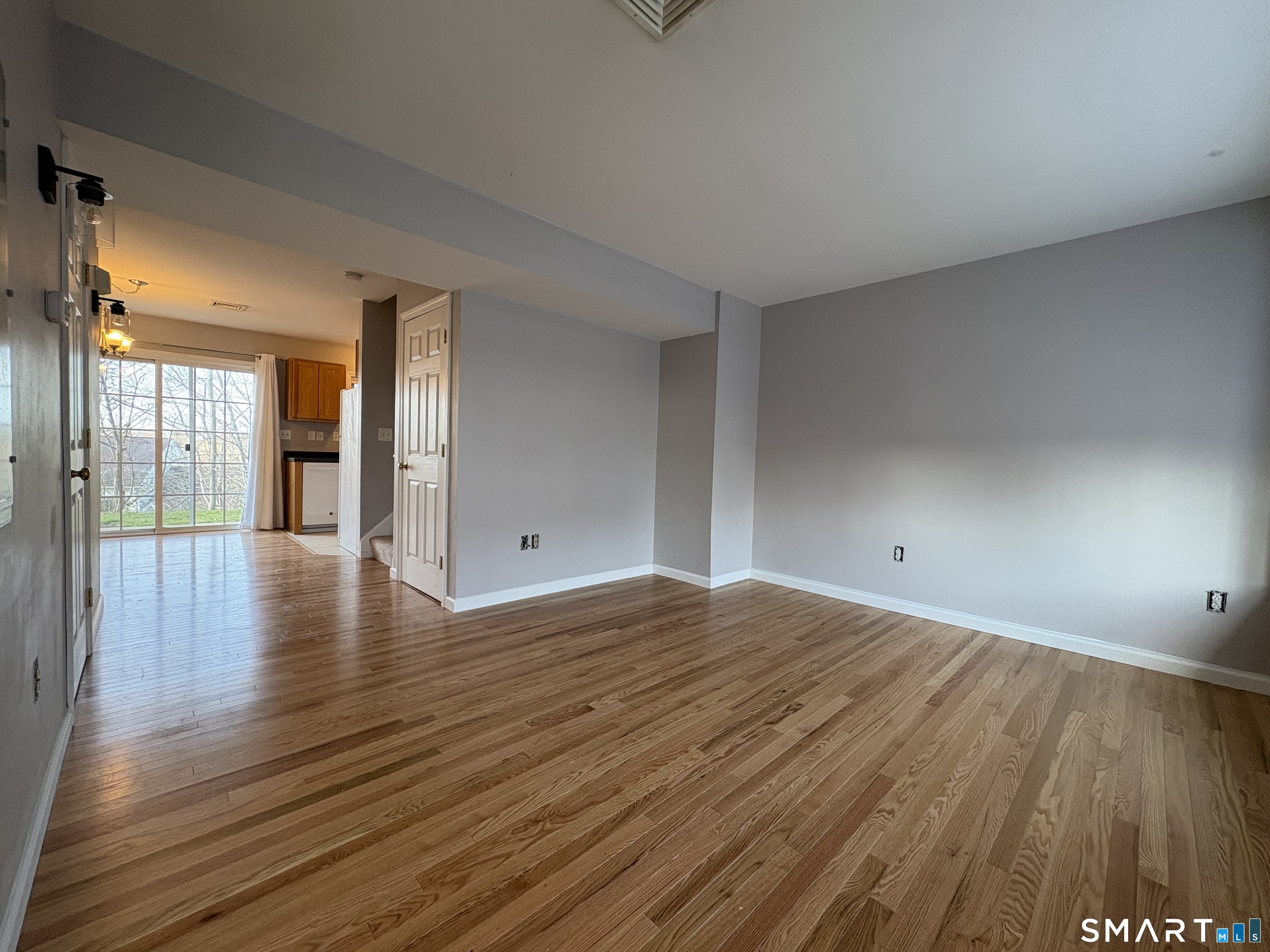 267 Bridge Street, Unit 18 Groton, CT 06340 - Photo 4 of 16 a view of a room with wooden floor and window