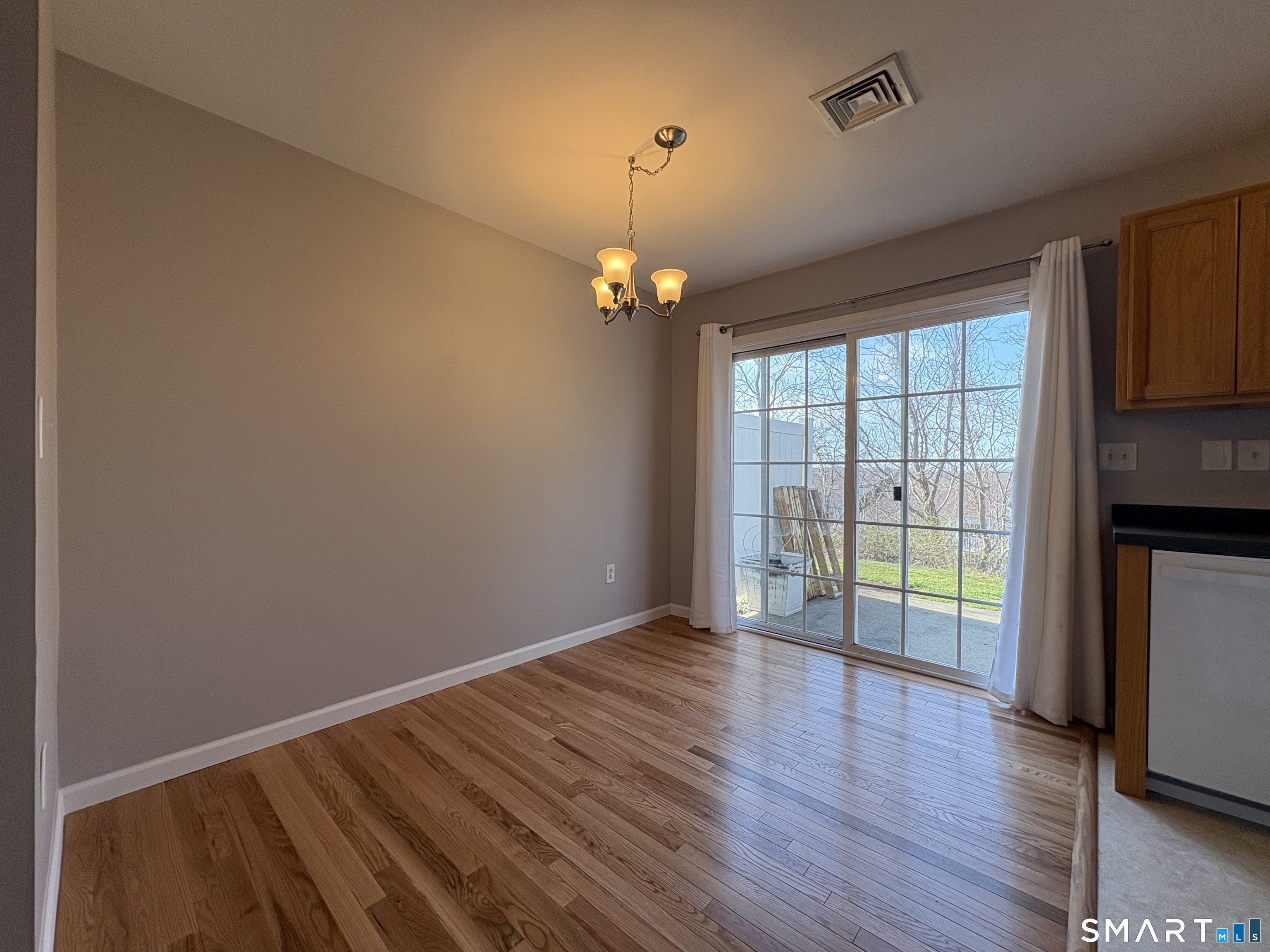 267 Bridge Street, Unit 18 Groton, CT 06340 - Photo 8 of 16 wooden floor in an empty room with a window