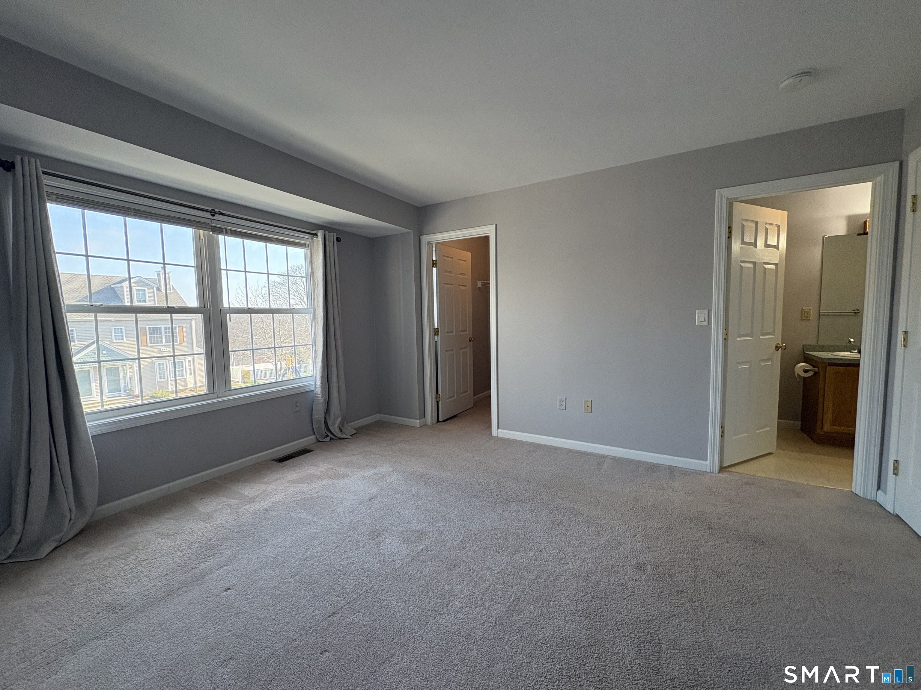 267 Bridge Street, Unit 18 Groton, CT 06340 - Photo 9 of 16 an empty room with windows and closet