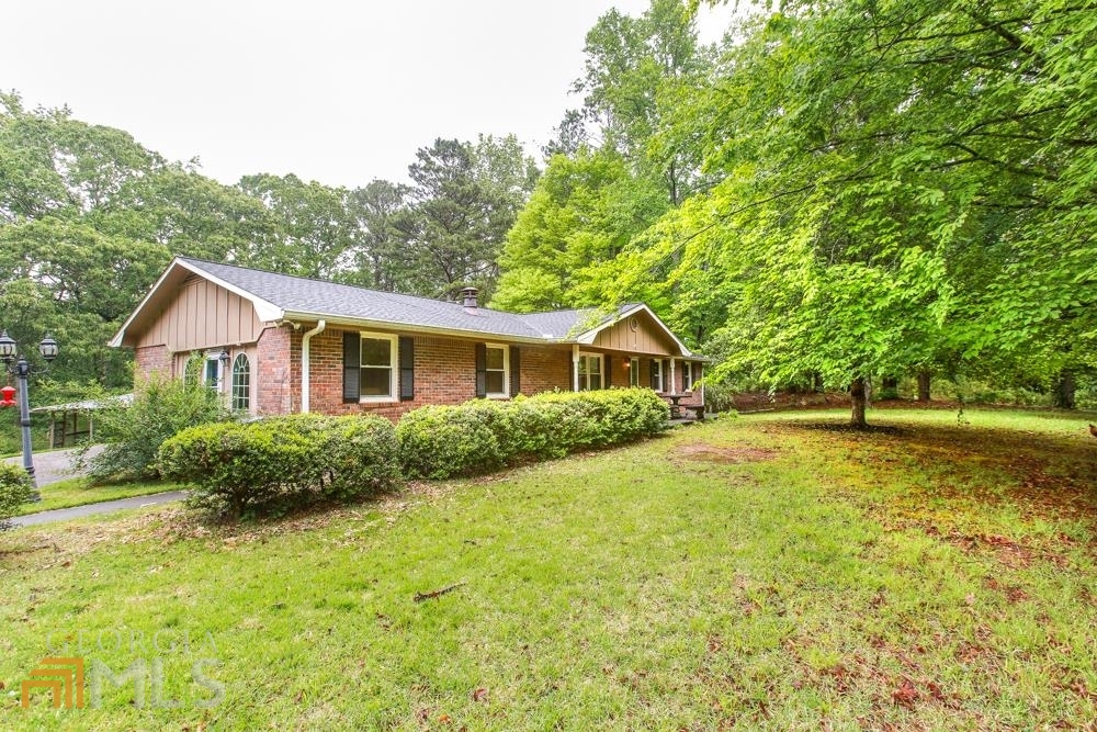 301 Lambert Road Whitesburg, GA 30185 - Photo 1 of 1 a view of a house with backyard and garden