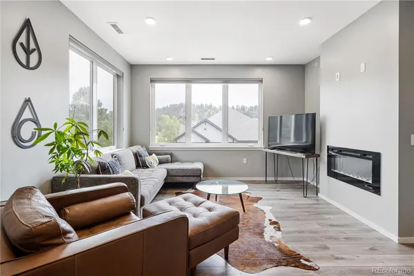 a living room with furniture and a floor to ceiling window