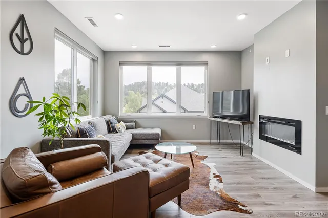 a living room with furniture and a floor to ceiling window