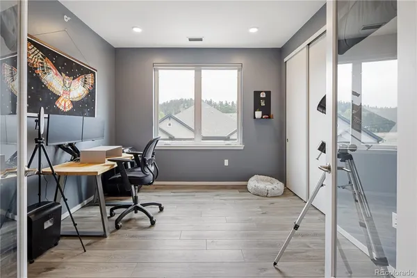 a workspace with furniture and a large window