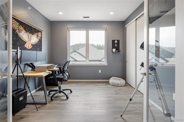 a workspace with furniture and a large window