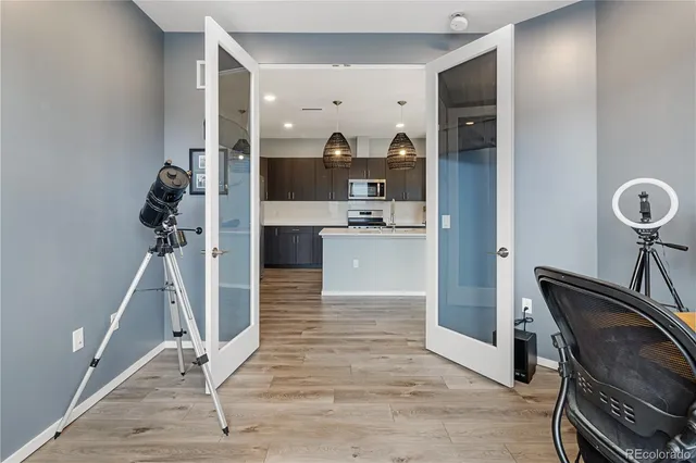 a view of a hallway with dining room and wooden floor