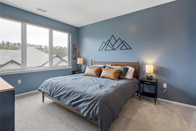 a bedroom with a bed and window