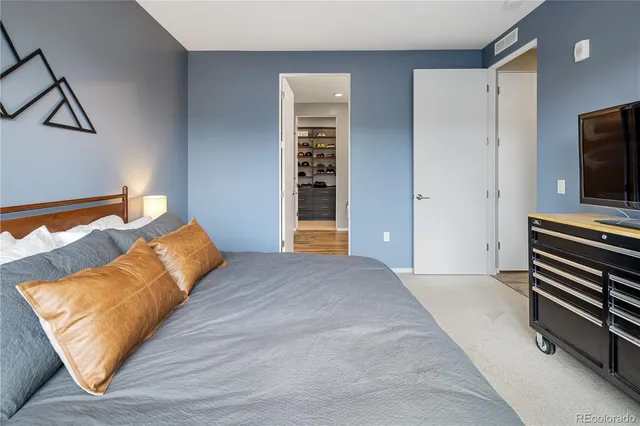 a bedroom with bed and flat screen tv