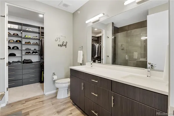 a bathroom with a double vanity sink toilet and shower