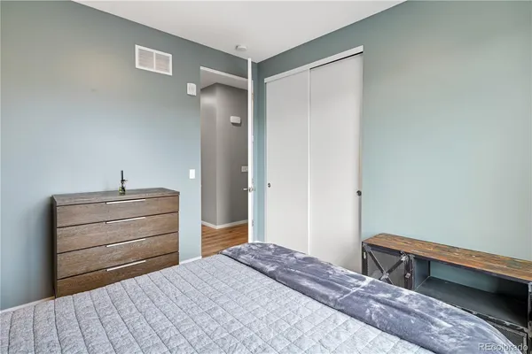 a bedroom with a bed and a dresser