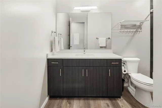 a bathroom with a sink a toilet a mirror and shower curtain