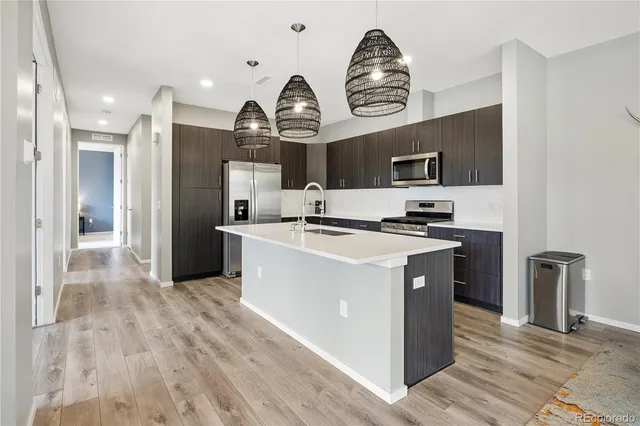 a kitchen with a sink stainless steel appliances and cabinets