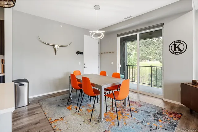 a dining room with furniture and wooden floor